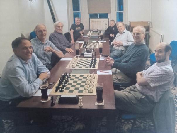 A group of men sitting around a table

AI-generated content may be incorrect.