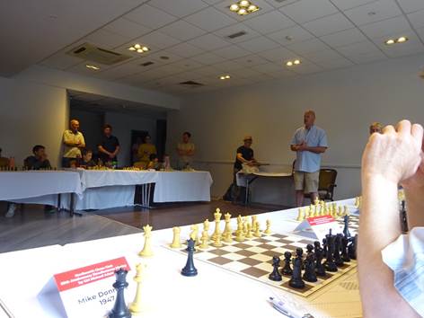 A group of people standing in front of a chess board

AI-generated content may be incorrect.