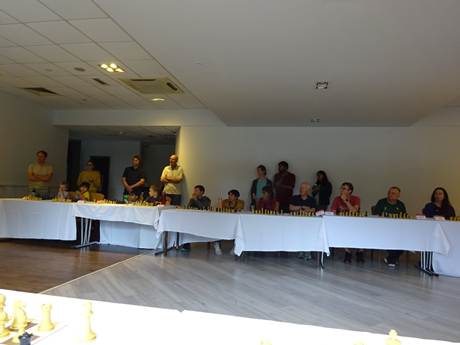 A group of people standing in a room

AI-generated content may be incorrect.